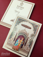 KLB890 Raja Rani Design Creme Color Premium 3D Gold Foil Hardboard Padding Thick Wedding Card (2 Page & Couple Name Wooden Plate)-Kalash Cards