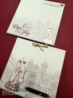 KLB736 Dulha Dulhan Royal Fort Design Creme Color Semi Box Wedding Card (2 Page & Couple Name Acrylic)