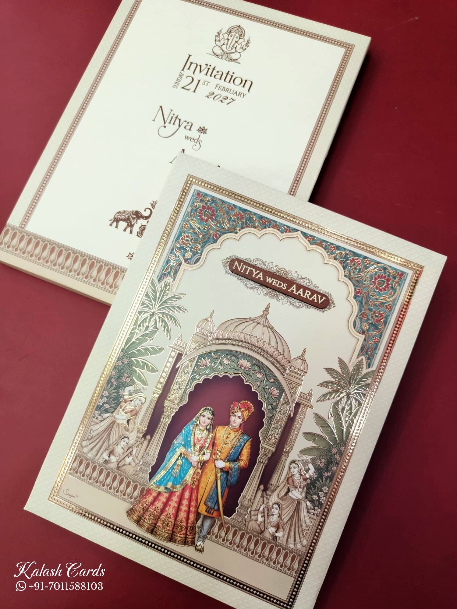 KLB890 Raja Rani Design Creme Color Premium 3D Gold Foil Hardboard Padding Thick Wedding Card (2 Page & Couple Name Wooden Plate)