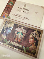 KLB943 Creme Brown Radha Krishna Ganesh Ji Padded Thick Wedding Card (2 Page & Couple Name Wooden Plate)